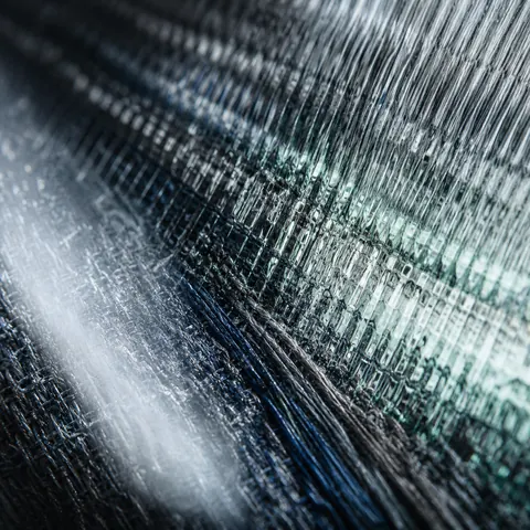 Abstract indigo textile and ribbed optical material in close detail